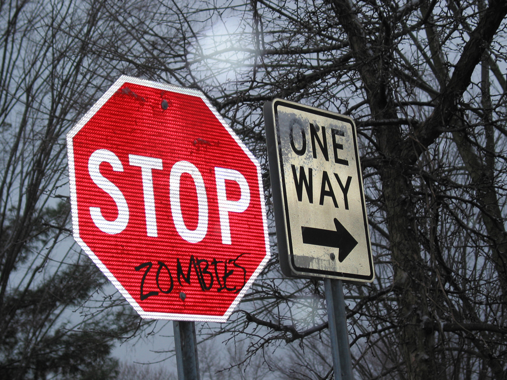 Vandalized Stop Signs With Many Messages